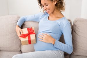 Eine schwangere Frau hat ein Geschenk erhalten.